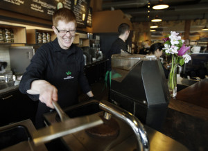 FILE - In this Friday, April 27, 2012 file photo, Starbucks barista Linsey Pringle prepares a cup of coffee at a Starbucks Corp. store in Seattle. Starbucks on Monday, June 16, 2014 announced a new partnership with Arizona State University to make online degrees available to its 135,000 U.S. employees who work at least 20 hours a week. (AP Photo/Ted S. Warren, File)